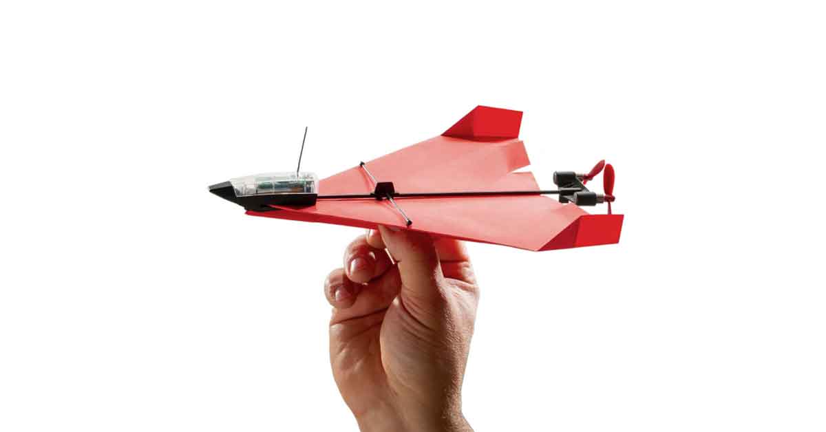 A hand holding the POWERUP 4.0 Next-Generation Smartphone Controlled Paper Airplane