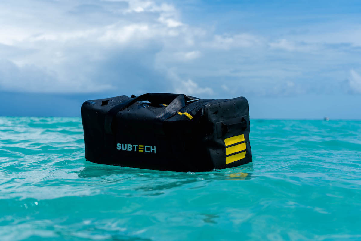 8 pieces of outdoors gear that are disrupting the outdoors industry. In this image, there is a DRYBAG 3.0 floating on the surface of the water, keeping its contents fully dry.