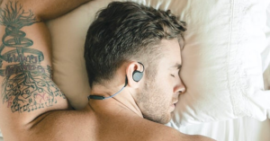 Man wearing bedphones sleep headphones to bed.