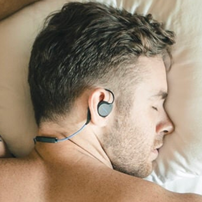 Man wearing bedphones sleep headphones to bed.