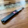 Flipped Tools out the front bottle opener, sporting its small form factor, on a wooden table.
