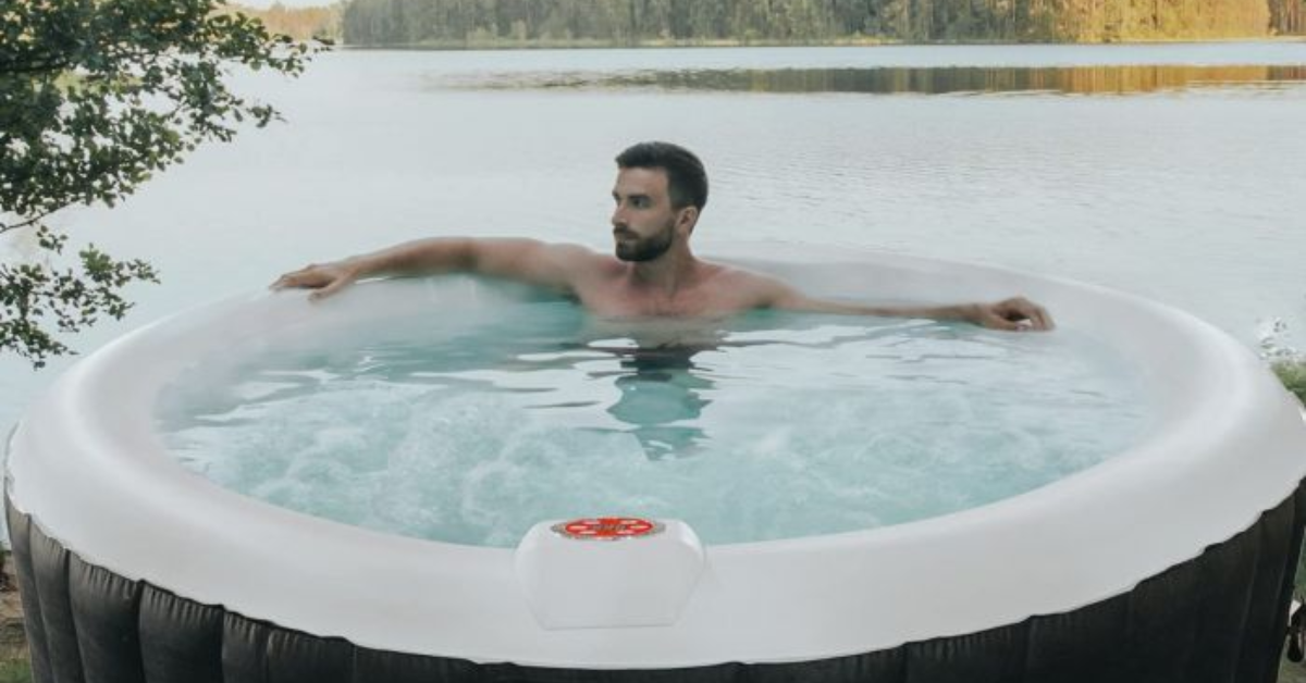 A person using the Aqua Spa Inflatable Jacuzzi outside.
