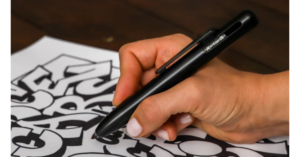 The MARKSMITH Black Ti Bolt Action Pen being used.
