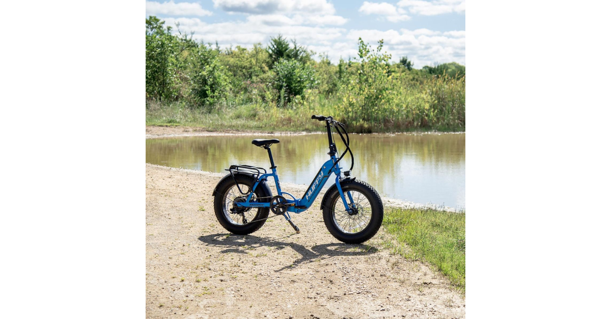 The Motoric Folding Electric Bike from Huffy Bikes outside next to a lake.