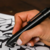 The MARKSMITH Black Ti Bolt Action Pen being used to draw.