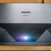 The Philips Screeneo U5 4K Projector on a table.