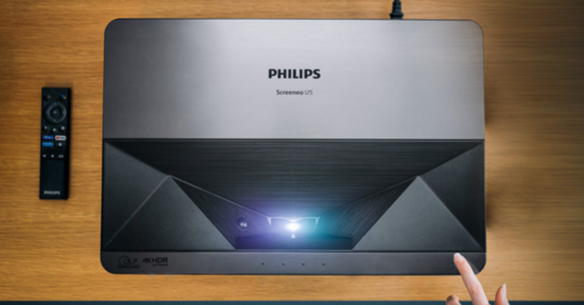 The Philips Screeneo U5 4K Projector on a table.