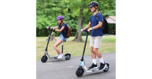 Two people enjoying a leisurely ride on electric scooters.