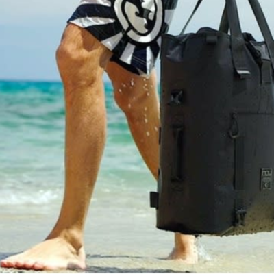 The LEVANTE Waterproof Modular Daily Backpack being carried on the beach.