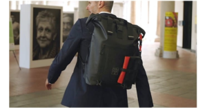 A person carrying the Levante Waterproof Modular Backpack on a business trip.